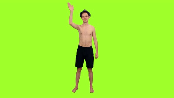 Young Shirtless Man Stands and Waving Hand Hello 