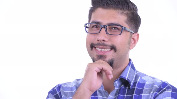 Face of Happy Bearded Persian Hipster Man Thinking alt