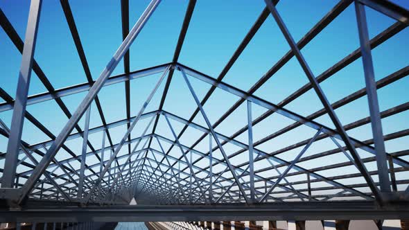 Seamless looping shot with camera moving along the unfinished steel roof alt