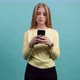 Young Concentrated Woman Using Smartphone, Serious Surprised Girl Texting on Her Phone - VideoHive Item for Sale