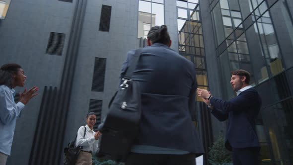 Confident Leader Celebrating Success with Team Outdoor alt