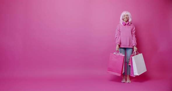 Happy Woman After Successful Shopping with Her Dog Isolated on Pink Background alt