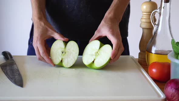 A Piece Of Unpeeled Green Apple Being Cut On Cubes Using Sharp Kitchen Knife. - Close Up alt