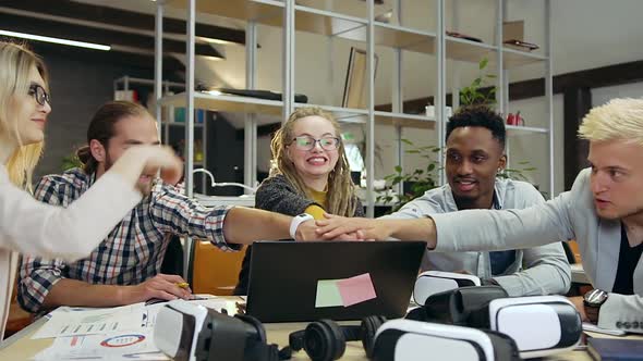 Young International Collegues which Putting Hands on Each other Before Successful Start to Work alt