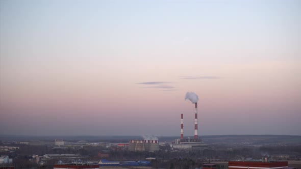 Pipes at the Plant Emit Harmful Substances Into the Atmosphere Near the City. alt
