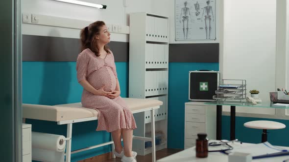 Portrait of Woman Expecting Child at Medical Appointment alt