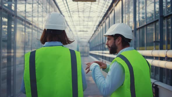 Engineering Supervisors Examining Factory Analysing Data Discussing Safety alt