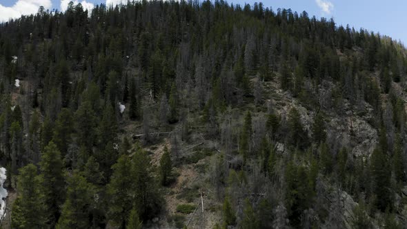Epic Aerial Shot Ascending Up the Side of a Mountain, Revealing More Mountains (Frisco, Colorado) alt