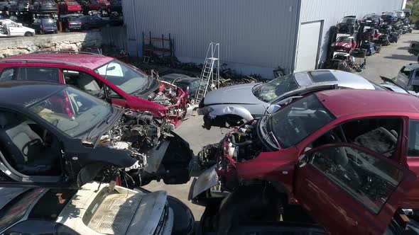 Crushed Car on Salvage Yard Lying in a Pile of Scrap Metal alt