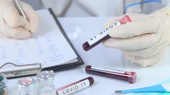 Doctor hands Holding COVID 19 Test Blood 
