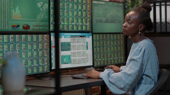 Female Investor Analyzing Forex Exchange Market on Multiple Monitors alt