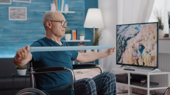 Elder Person with Disability Stretching Resistance Band to Exercise alt