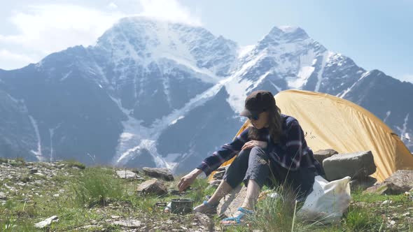 Lady Stirs Soup Boiling in Hiking Bowler with Spork alt