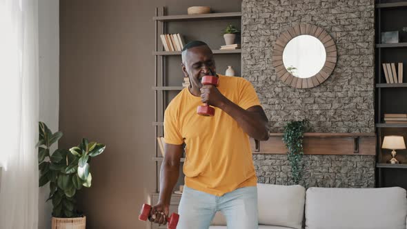 Comical Active African Athletic Sportsman Fit Strong Senior Man Make Gymnastic Exercises at Home alt