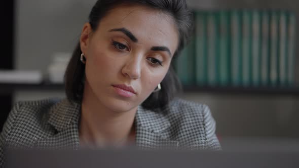 Portrait of Ambitious Muslim Business Woman Working with Laptop Indoors at Home Concentrated on alt