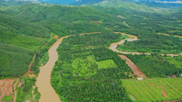 4K : Aerial view over farmland and hill farming alt