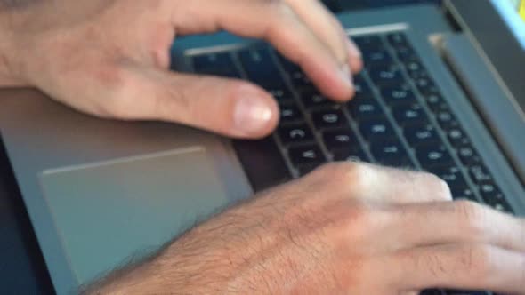 Close Shot of Male Hands Typing on a Laptop Computer alt
