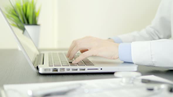 Doctor Working With Laptop alt