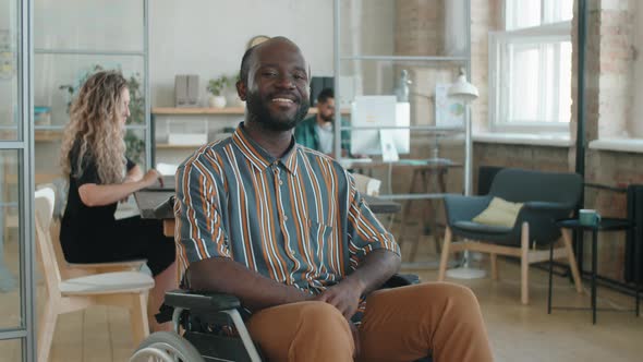 Portrait of Cheerful Afro Businessman in Wheelchair in Office alt