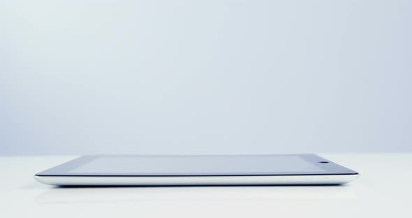 Close-up of digital tablet on table alt