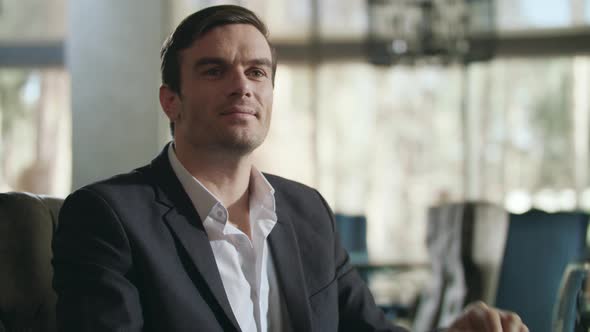 Businessman Calling Waiter at Restaurant. Handsome Man Gesturing Hand at Cafe alt