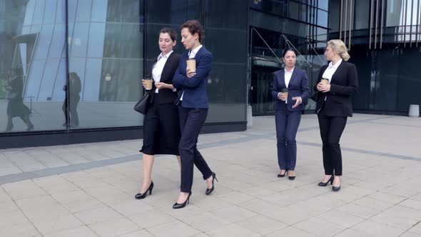 Four Women Walking in Couples Having Business Conversation and Coffee Break