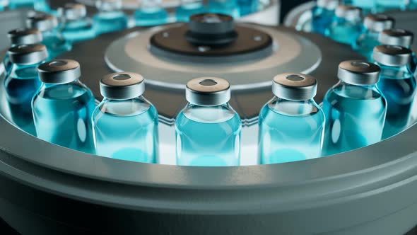 Blue vaccine bottles on the conveyor belt. Concept of COVID-19 vaccination. alt