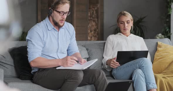Focused European Couple Coworkers Working Together at Home Office Online Lesson Chatting Internet alt