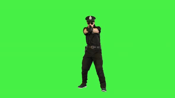 Young Caucasian Policeman Appears Makes a Shoot and Walks Away on a Green Screen Chroma Key
