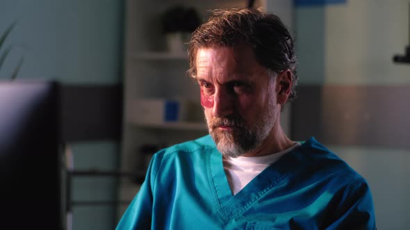 Mature Medical Practitioner Applying Eye Patches and Speaking with Reflection alt