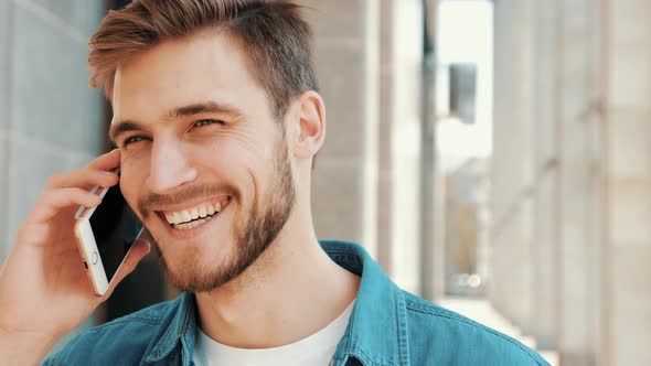 Handsome smiling man in casual clothes outdoors alt