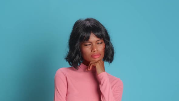 Thoughtful Young Woman Holds Chin Looks Away Pensively Tries To Make Decision alt
