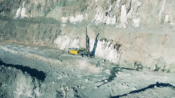 Quarry Site with a Drilling Machine Filmed From Above alt