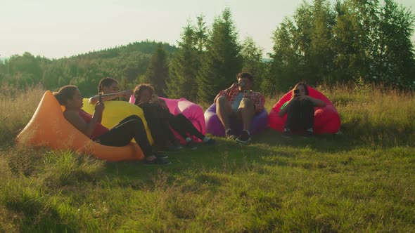 Diverse Multiethnic Friends Addicted to Smartphones Ignoring Each Other During Summer Vacations alt