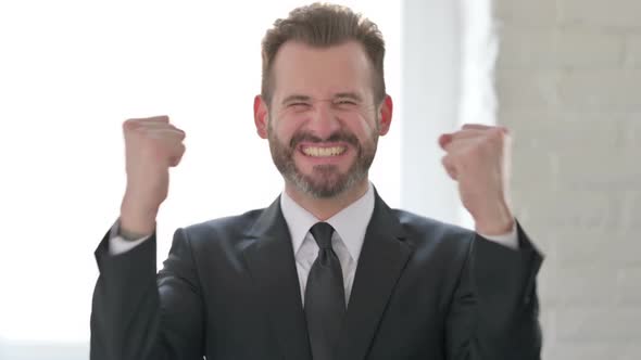Excited Middle Aged Businessman Celebrating Success alt