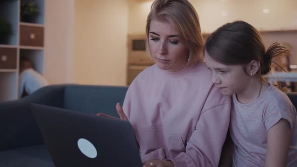 Woman Is Serious Teaching Young Girl Browsing Online