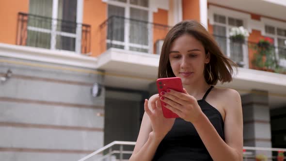 Cute Girl Use Red Smartphone Outdoor