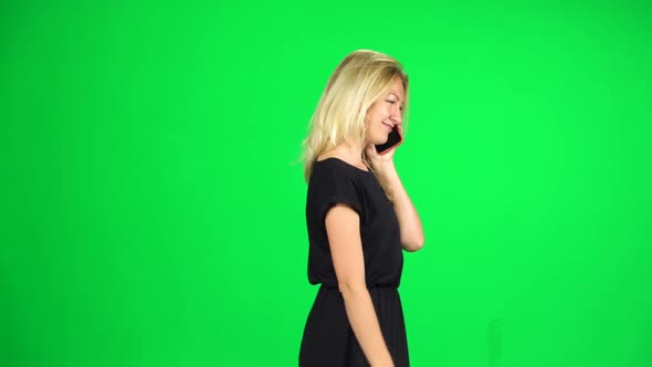 Girl Goes and Speaks on the Phone. Chroma Key. Slow Motion. Side View alt