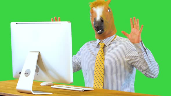 Shocked and Scared Businessman in Horse Mask Looking at Broken Computer with Reports Disappearing on