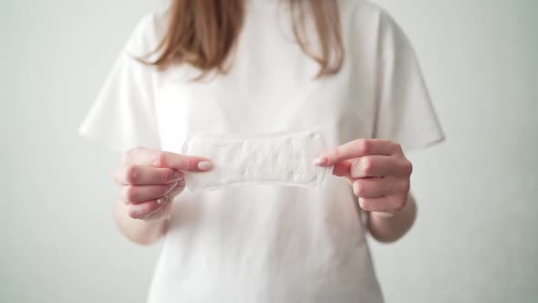 A Woman with a Period Holds a White Pad