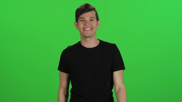 Young man points upwards happily (use for info pop-up's) alt