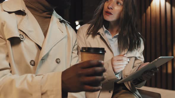 Two Colleagues Working In Evening alt