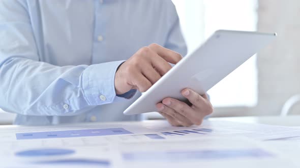 Close Up of Young Guy Using Tablet in Modern Office alt