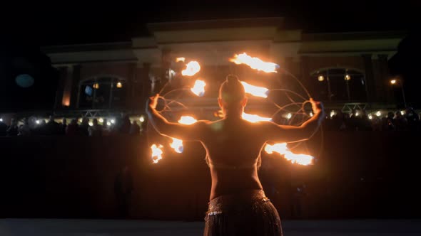 Beautiful girl seductively dances and plays with fire