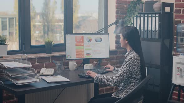 Entrepreneur Designing Business Charts on Computer alt