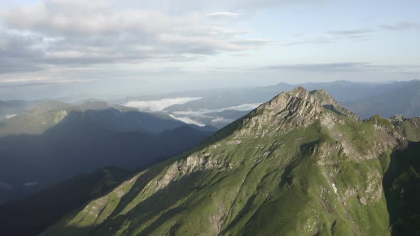 Natural Mountain Peak Cliff Terrain at Morning Surrounded Cloudy Blue Sky Organic Landscape alt