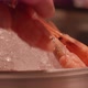Man's and woman's fingers take shrimps lying on ice in a big plate - VideoHive Item for Sale