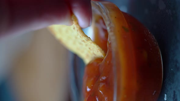Closeup of Dipping Tortillas Chip in Salsa Sauce