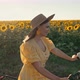 Free Woman in Long Dress Riding Retro Styled Bicycle on Country Road Near Sunflowers Field - VideoHive Item for Sale