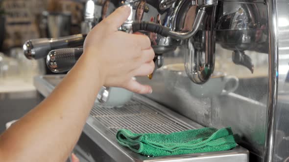 Barista Steaming Milk in Frothing Pitcher Preparing Drinks for Coffee Shop Customers